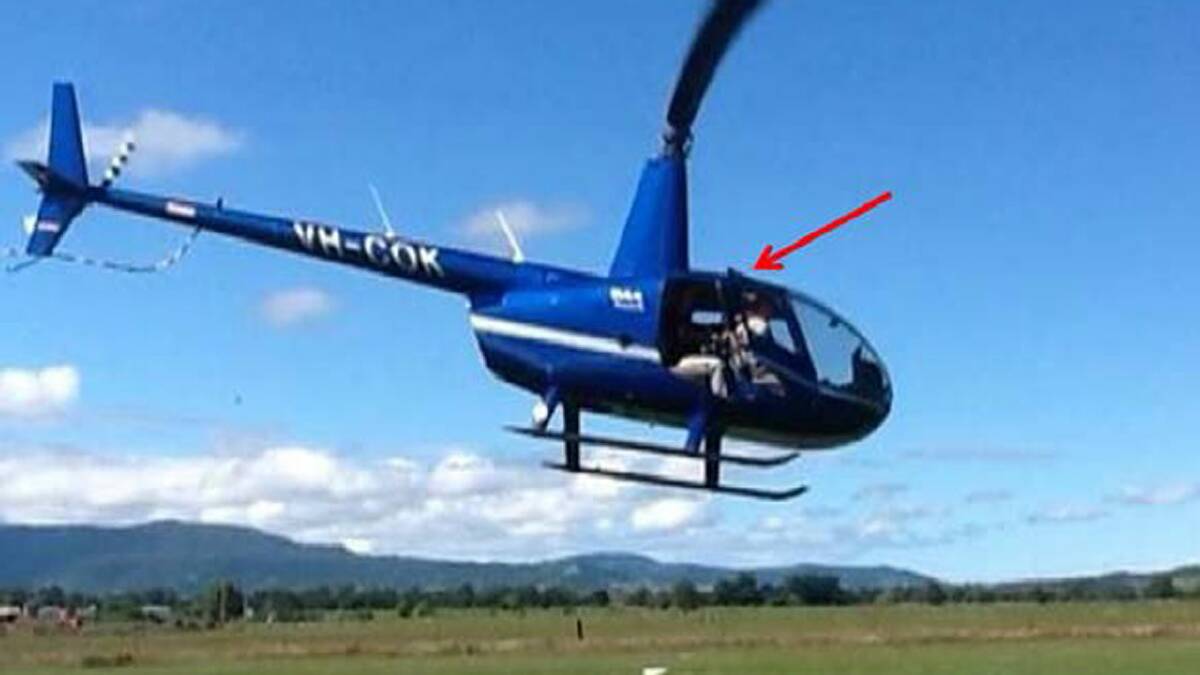OPEN DOOR: The Robinson R44 with the open door shortly before it crashed on February 4 last year. 	Photo: DAVID BENNETT