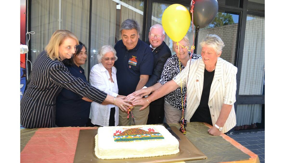 NSW National Parks and Wildlife Service deputy chief executive Ann King, Cullunghutti committee members Lena Bloxsome, Jean Baden- Davenport and chair of elders organisation for the Shoalhaven and Jerringa council chair Gordon Wellington, MP for Kiama Gareth Ward, Federal member for Gilmore Ann Sudmalis and Mayor Joanna Gash cut the honourary cake for Cullunghutti Aboriginal Area celebrations at Shoalhaven Heads Community Centre on Friday.