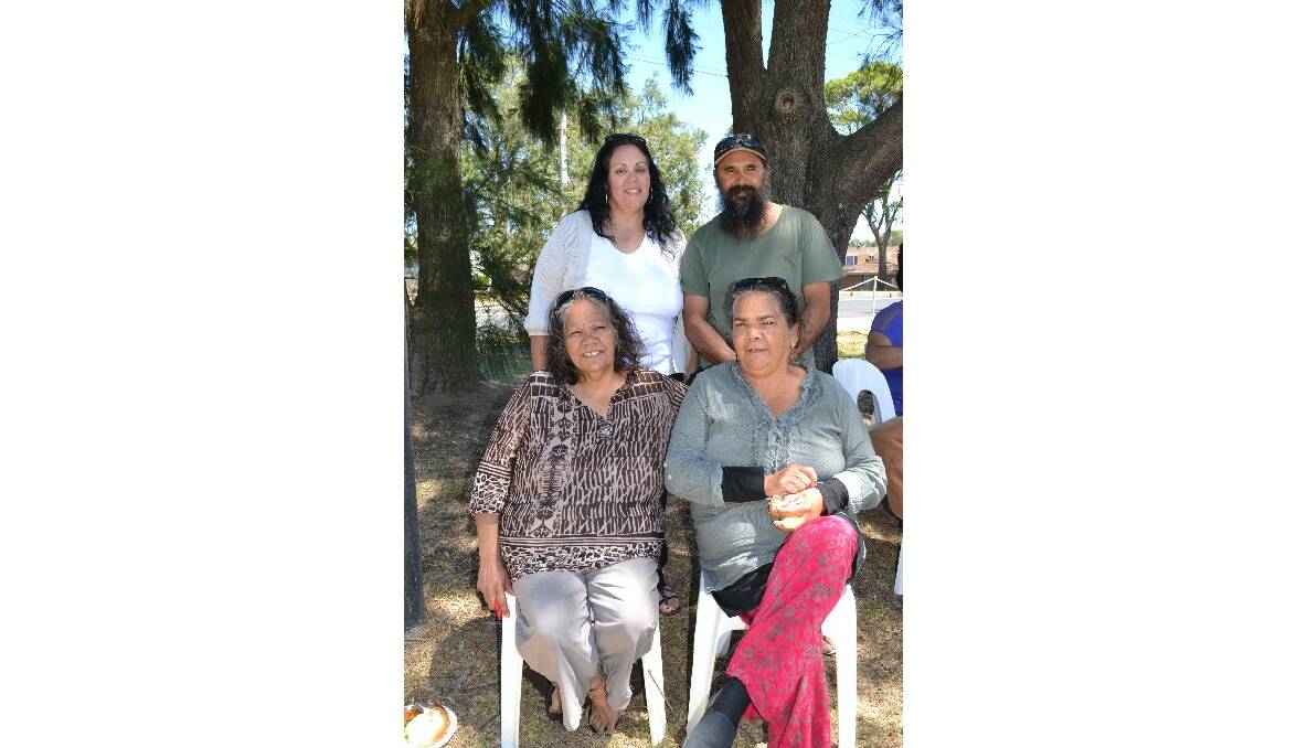 (back) Leanne Ball from Vincentia, Phillip Lonesborugh from Wreck Bay and (front) Annette Brown and Wendy Brown from Wreck Bay enjoy something to eat at the Cullunghutti Aboriginal Area community celebration at the Shoalhaven Heads Community Centre on Friday.