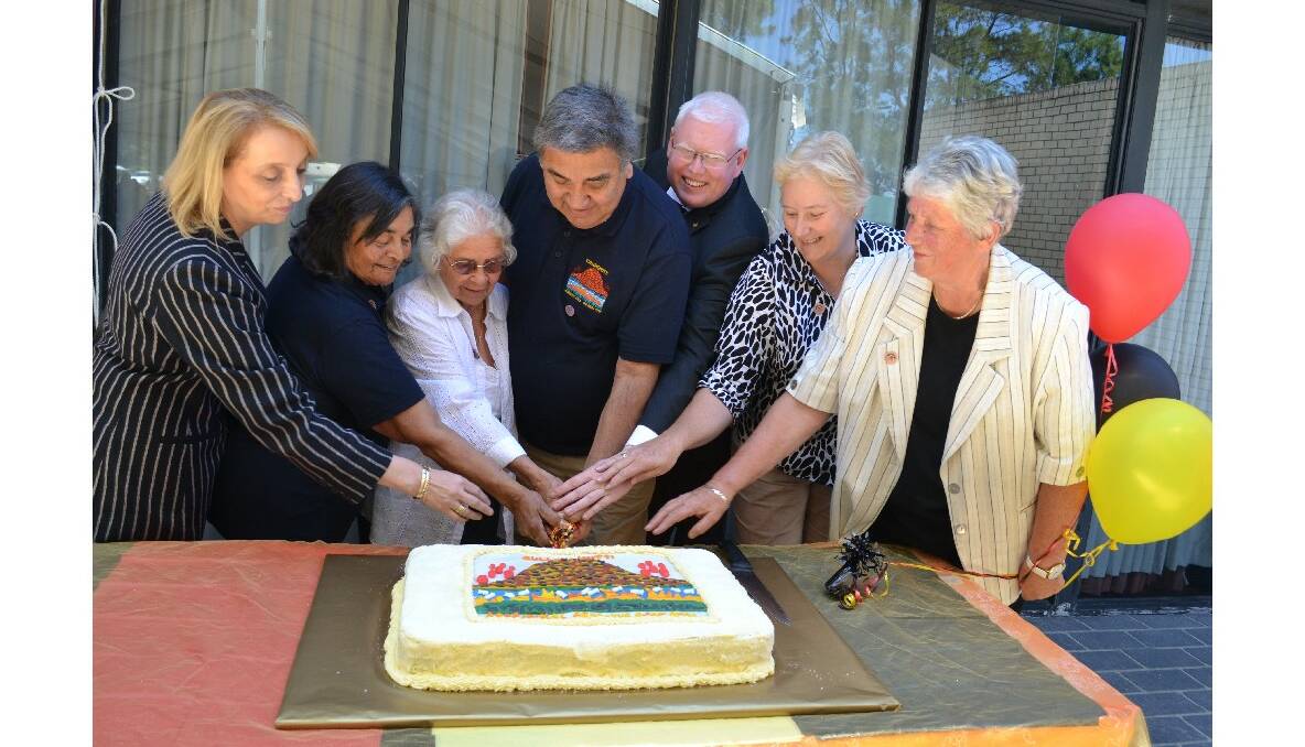 NSW National Parks and Wildlife Service deputy chief executive Ann King, Cullunghutti committee members Lena Bloxsome, Jean Baden- Davenport and chair of elders organisation for the Shoalhaven and Jerringa council chair Gordon Wellington, MP for Kiama Gareth Ward, Federal member for Gilmore Ann Sudmalis and Mayor Joanna Gash cut the honourary cake for Cullunghutti Aboriginal Area celebrations at Shoalhaven Heads Community Centre on Friday.