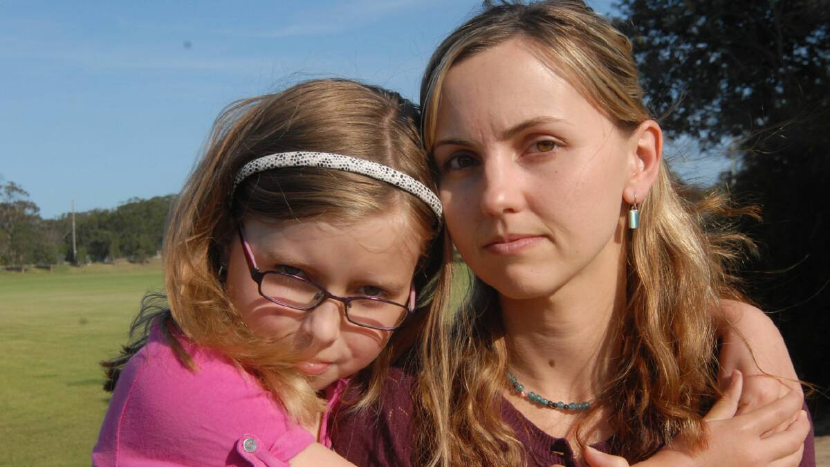 WORRIED: Emily Banks and her daughter Ceradwen live across the road from the Shoalhaven Heads sporting fields, where Telstra were planning to build a mobile phone tower. The application has now been withdrawn.