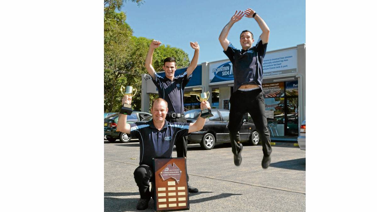 YOU BEAUTY: Proud owner of Mountain Side Meats at Shoalhaven Heads Nathan Alcock (front) celebrates his national sausage king with apprentice Brady Harris Monteith (centre) and butcher Kory Edwards.
