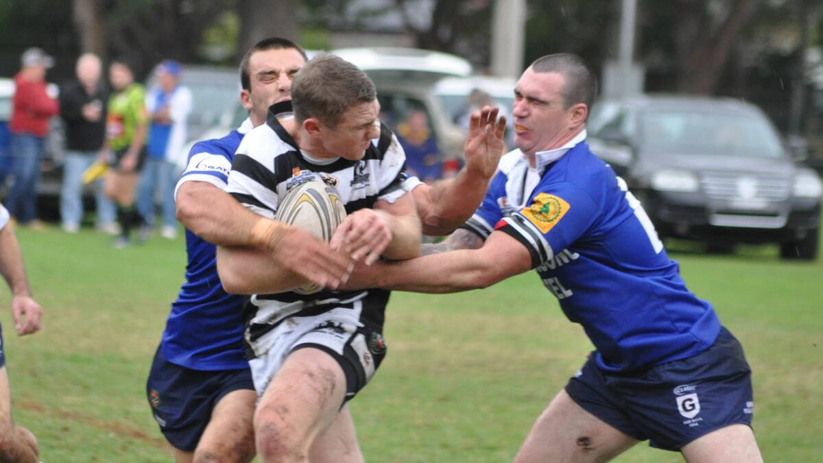 FIRST UP: Berry Magpies’ Blake Dryden gets tackled by Gerringong Lions’ Nathan Ford and Ryan Staples in the 2013 season.