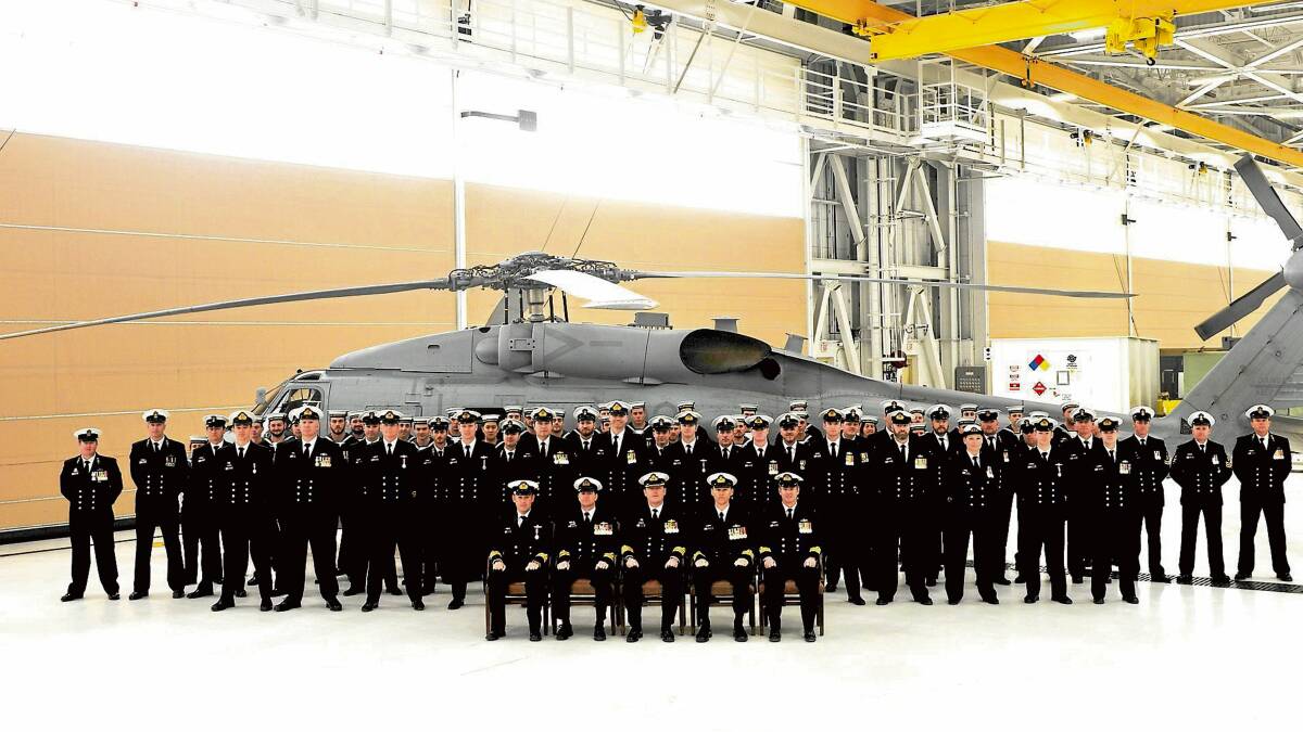 IT’S OURS: HMAS Albatross personnel at the official handover of the first two MH-60R Seahawk Romeo maritime combat helicopters in Florida.