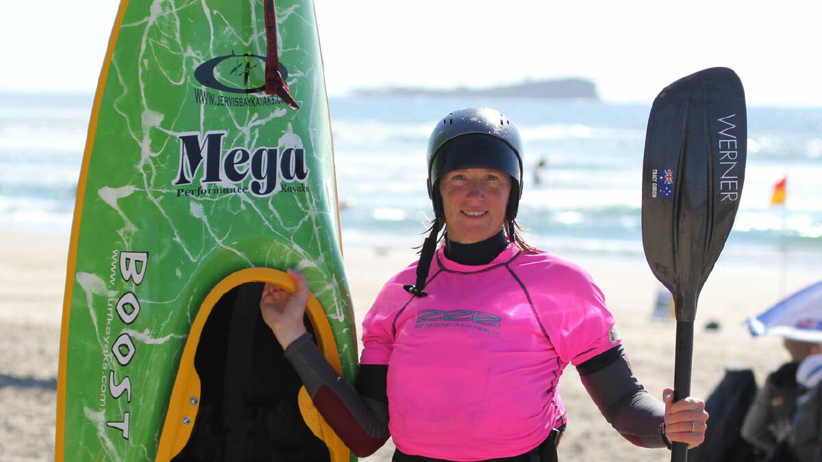 WONDER WOMAN: Jervis Bay’s Tracy Gibson is fresh from the surf at the World Surf Kayak Championships in Queensland earlier this month. 	Photo: JOHN GIBSON