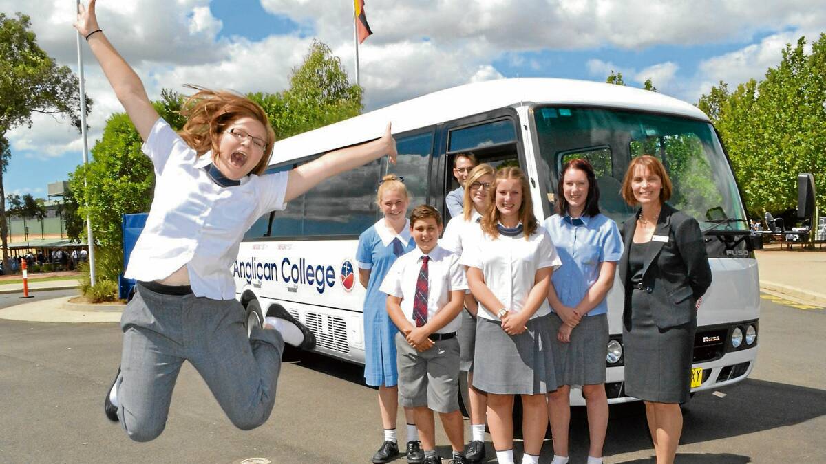 READY TO ROLL: Nowra Anglican College year 12 student Naomi Brown jumps for joy over the school’s new bus. She is joined by Lexie Templeton, Max Lans, Matthew Mack, Sarah Stewart, Chloe Toulson, Sarah Wearne and principal Lorrae Sampson.