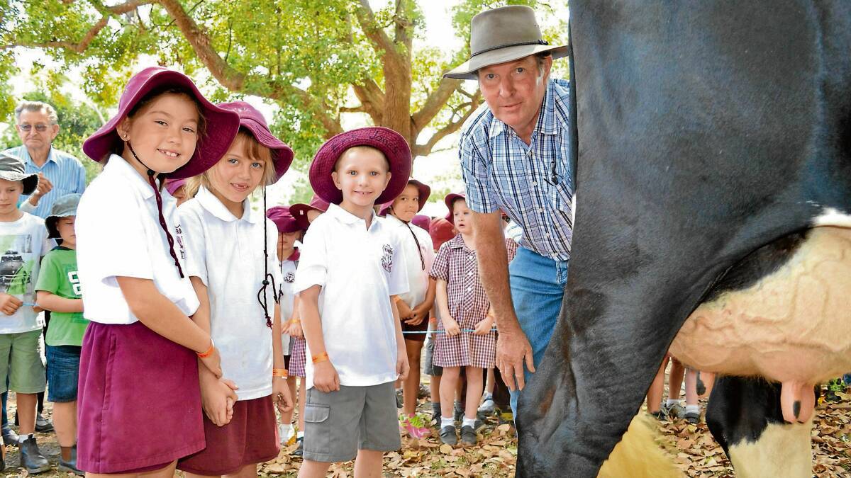 UDDERLY FASCINATING: Nowra Public students, Sophie Elliott, Kaylah Cheney and Eric Janes get a close-up view of the milking demonstration at this year’s Nowra Show with Pat Muller.