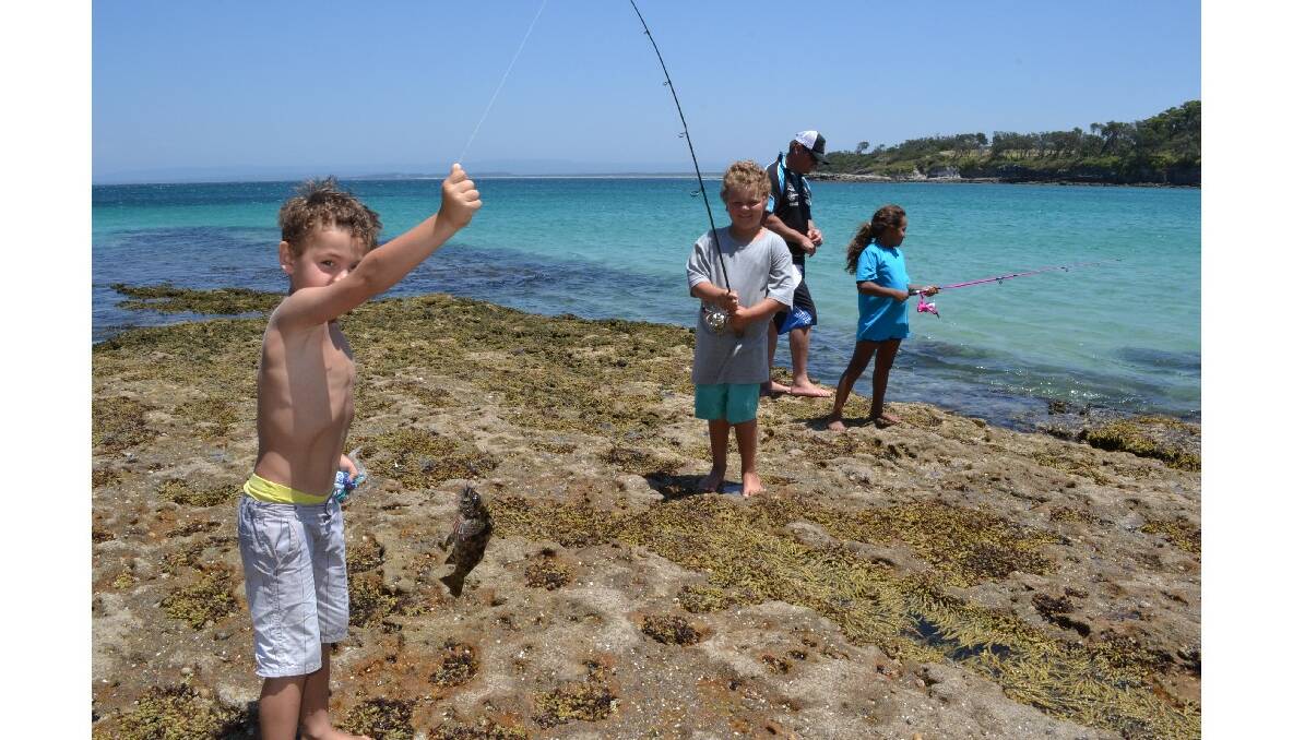 Ben and Tim Askew from Jervis Bay catch their first fish for the day at the Australian Federal Police and Wreck Bay indigenous community ‘Off the Hook’ kids’ fishing fun day at Summercloud Bay on Wednesday. 