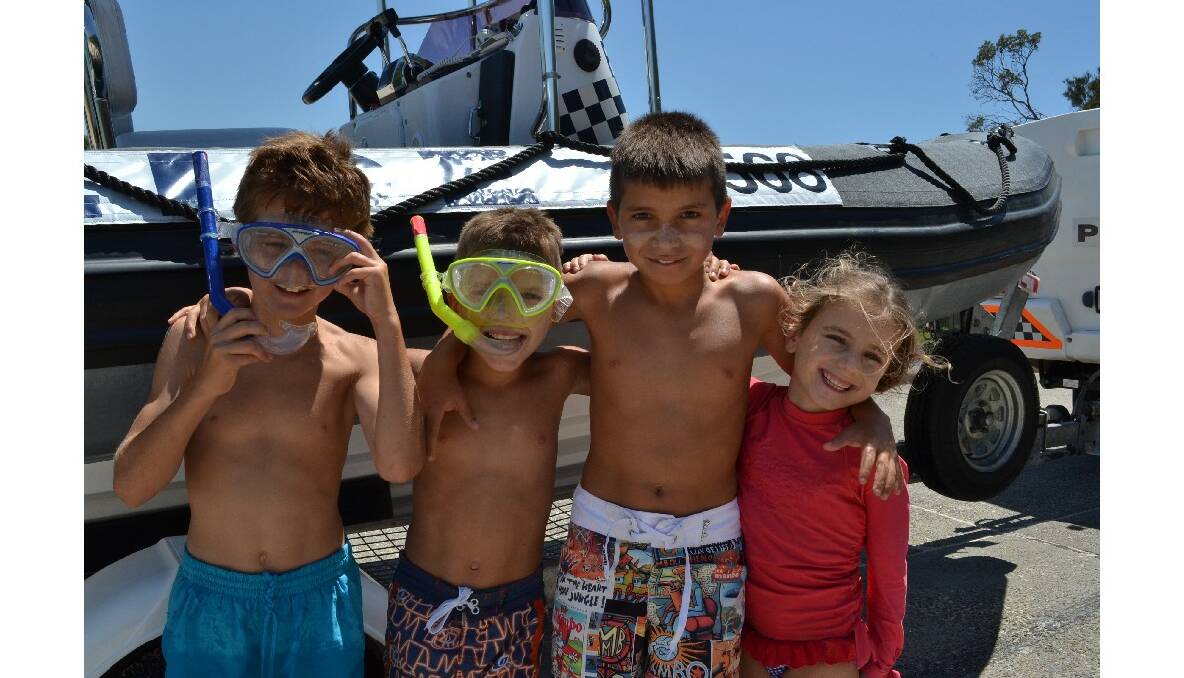 Alexander Mascioli, Xavier Tsagaris, Salvatore and Cartier Velickovski from Vincentia enjoy a day out on the beach at the Australian Federal Police and Wreck Bay indigenous community ‘Off the Hook’ kids’ fishing fun day at Summercloud Bay on Wednesday.