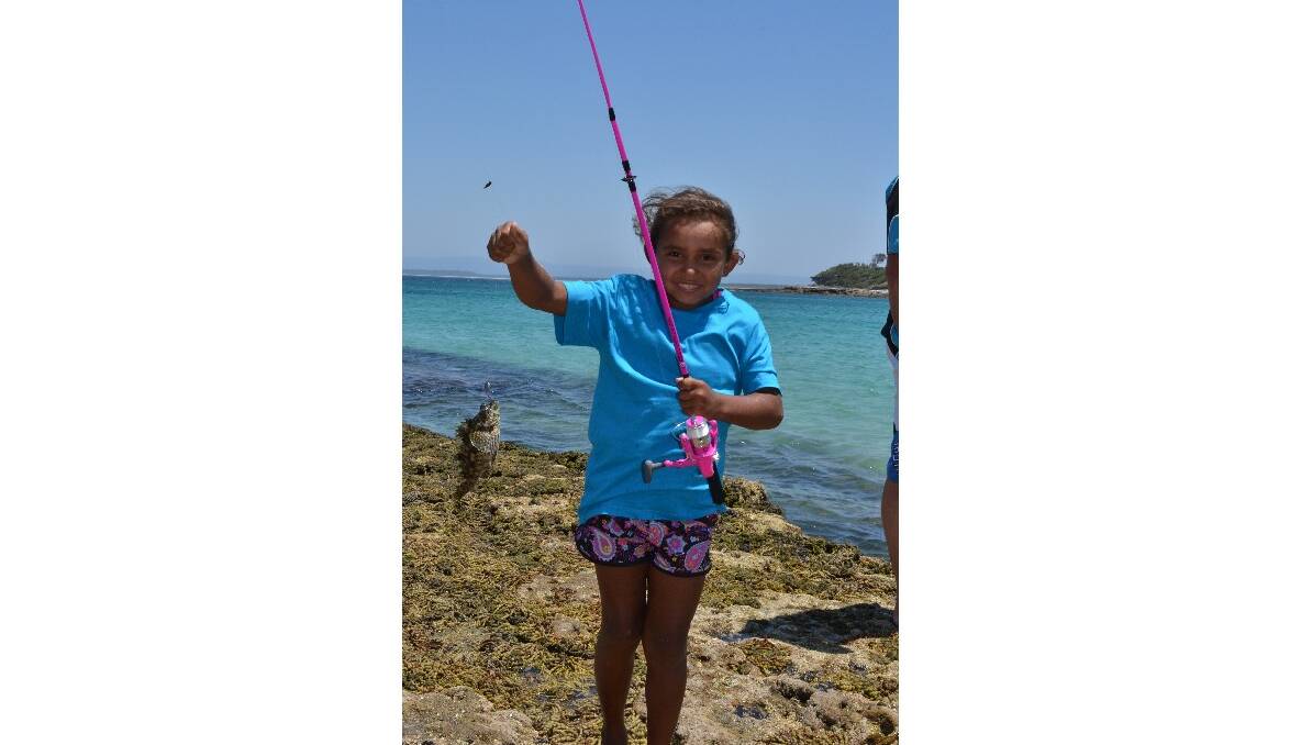 Keyala Brown from Jervis Bay catches a big fish at the Australian Federal Police and Wreck Bay indigenous community ‘Off the Hook’ kids’ fishing fun day at Summercloud Bay on Wednesday. 