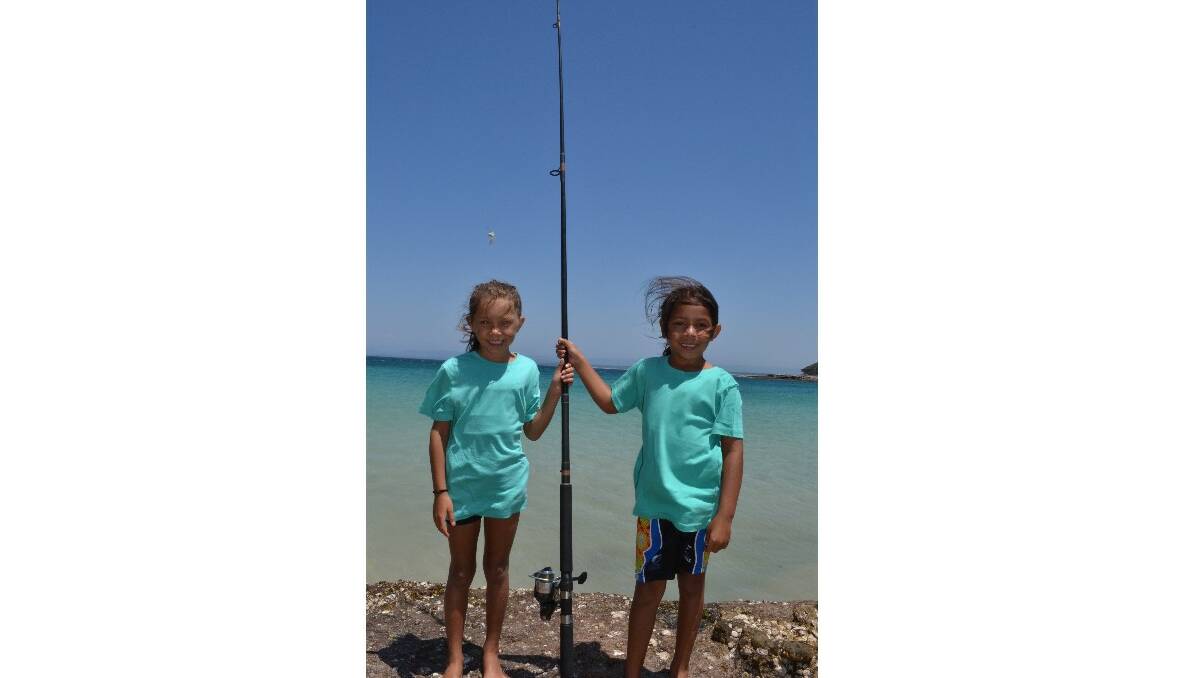 Priscilla and Angus Dann from Wreck Bay help each other to catch fish at the Australian Federal Police and Wreck Bay indigenous community ‘Off the Hook’ kids’ fishing fun day at Summercloud Bay on Wednesday. 