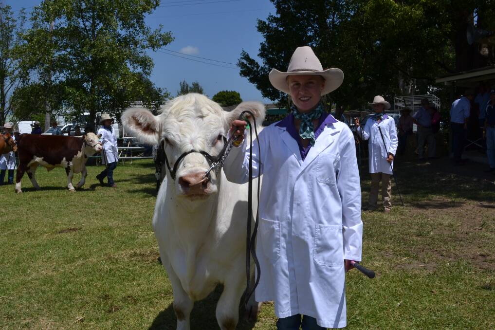 WINNERS ARE GRINNERS: Camilla Milne from Young with her steer ‘Albert’, who won the Weston Milling Animal Nutrition Junior Steer Competition at the Berry Show on Saturday.