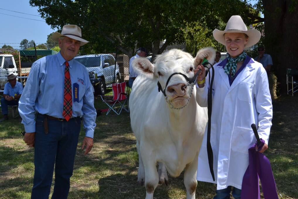 SUPREME DUO: Judge Stuart Warden from Livestock Auctioneers, AJ Campbell & and Camilla Milne from Young with her steer ‘Albert’, who won the Supreme Champion Heifer or Steer class at the Berry Show on Saturday.