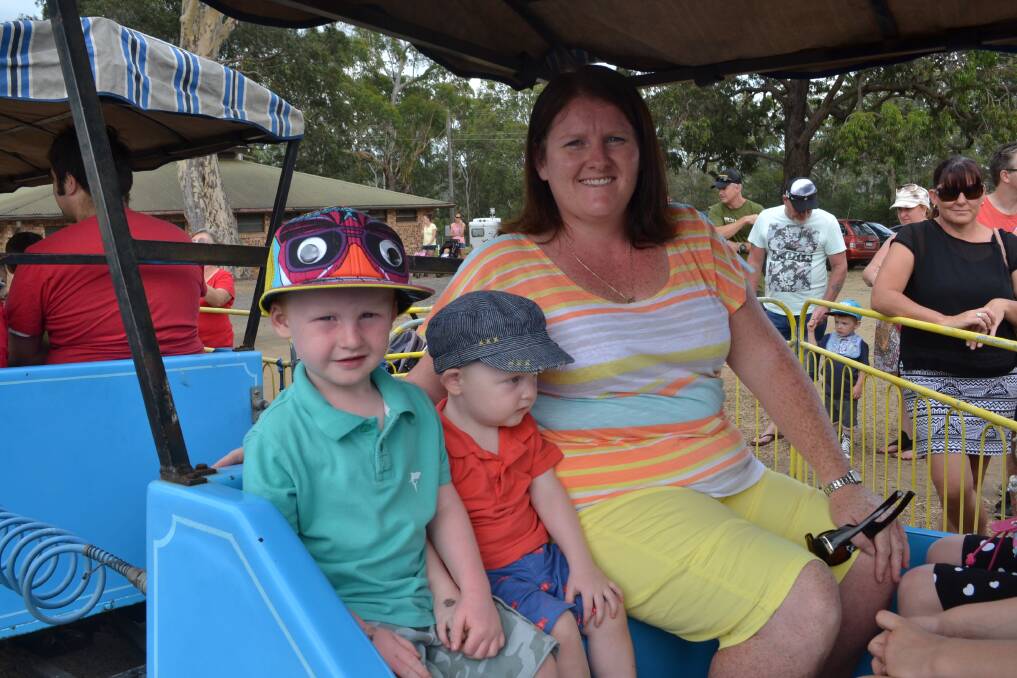 TRAIN RIDE: William, Benjamin and Leah Dunn from Orient Point enjoy the train ride at the Nowra Lions Club Kid’s Day Out at the Nowra Showground on Sunday.