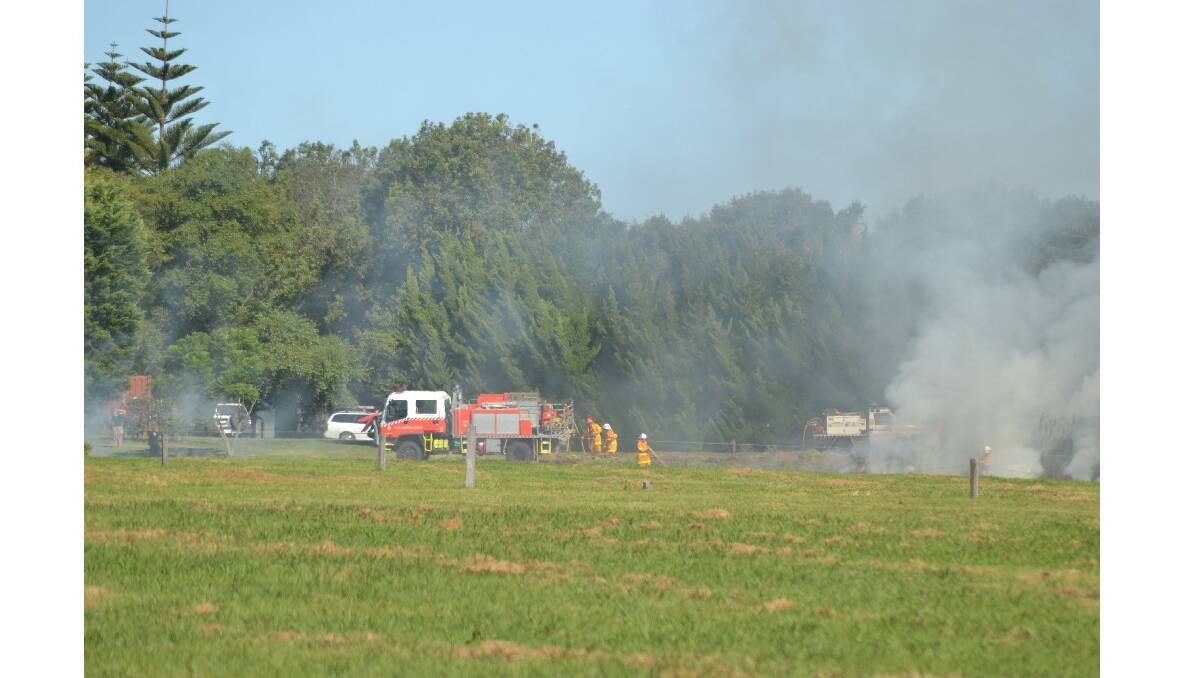 NSW Rural Fire Service crews extinguish a grass fire at the historic Terrara House property east of Nowra.