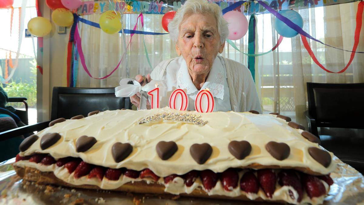 Ida Beard blows out the candles on her 100th birthday cake. Picture: TARA GOONAN, Border Mail