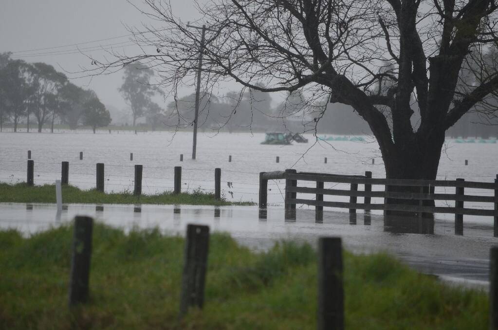 Stephen Taylor’s photo of water of a drowned tractor in flooded paddocks.