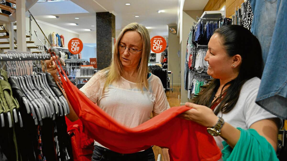 AT YOUR SERVICE: Lora Berryman (left) from Nowra Hill prefers to shop in store as opposed to online. Cotton On manager Yasmin Burk believes the gloss has dulled on the online shopping phase.