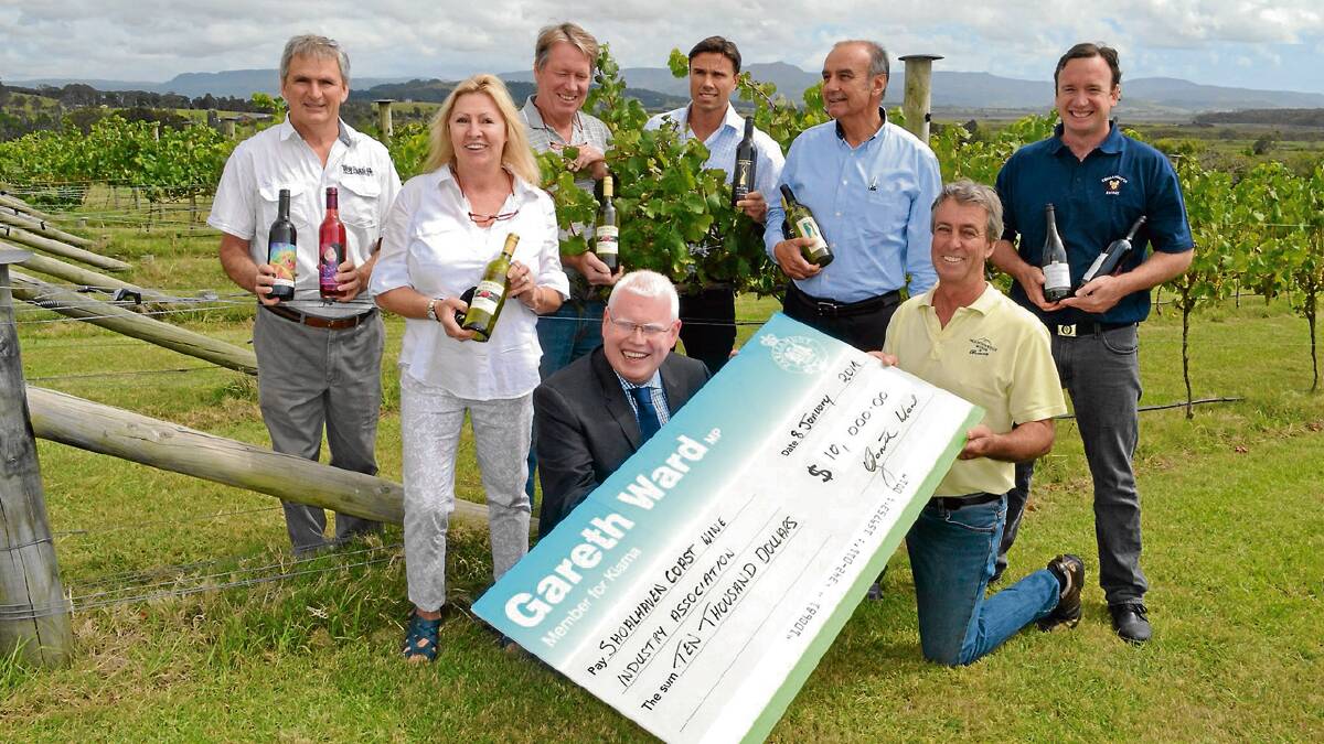 BACKING: The Shoalhaven Coast Wine Industry Association has received $10,000 from the NSW Government’s Regional Flagship Events Program to promote the Shoalhaven Winter Wine Festival in June. President of the Shoalhaven Coast Wine Industry Association, Barry Starkey accepts the cheque from Kiama MP Gareth Ward, watched by fellow vineyard operators (from left) Jeff Lester (Roselea Vineyard), Louise and Gary Peat (Cambewarra Estate), Joseph and Godwin Felice (Crooked River Winery) and Ben Wallis (Coolangatta Estate).