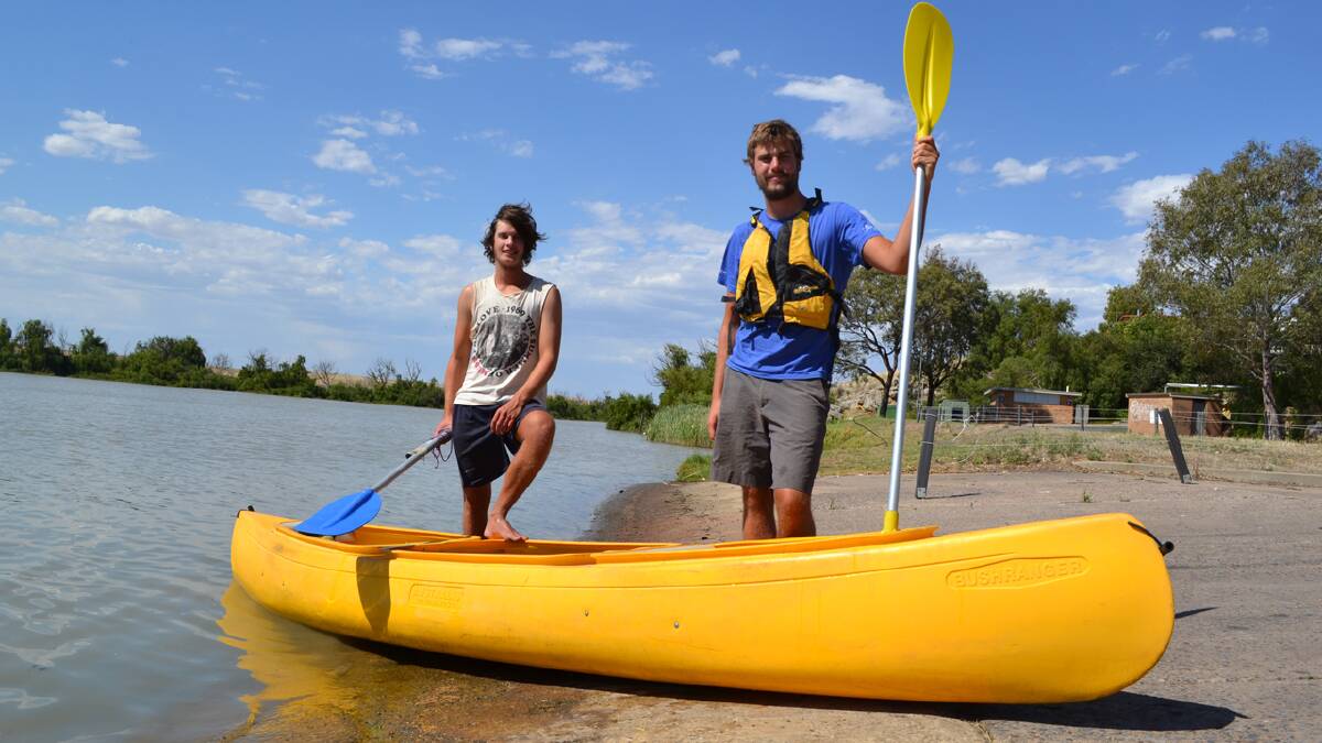 PADDLE: James Knight and John Miller during a break in their paddling journey in Murray Bridge, South Australia.