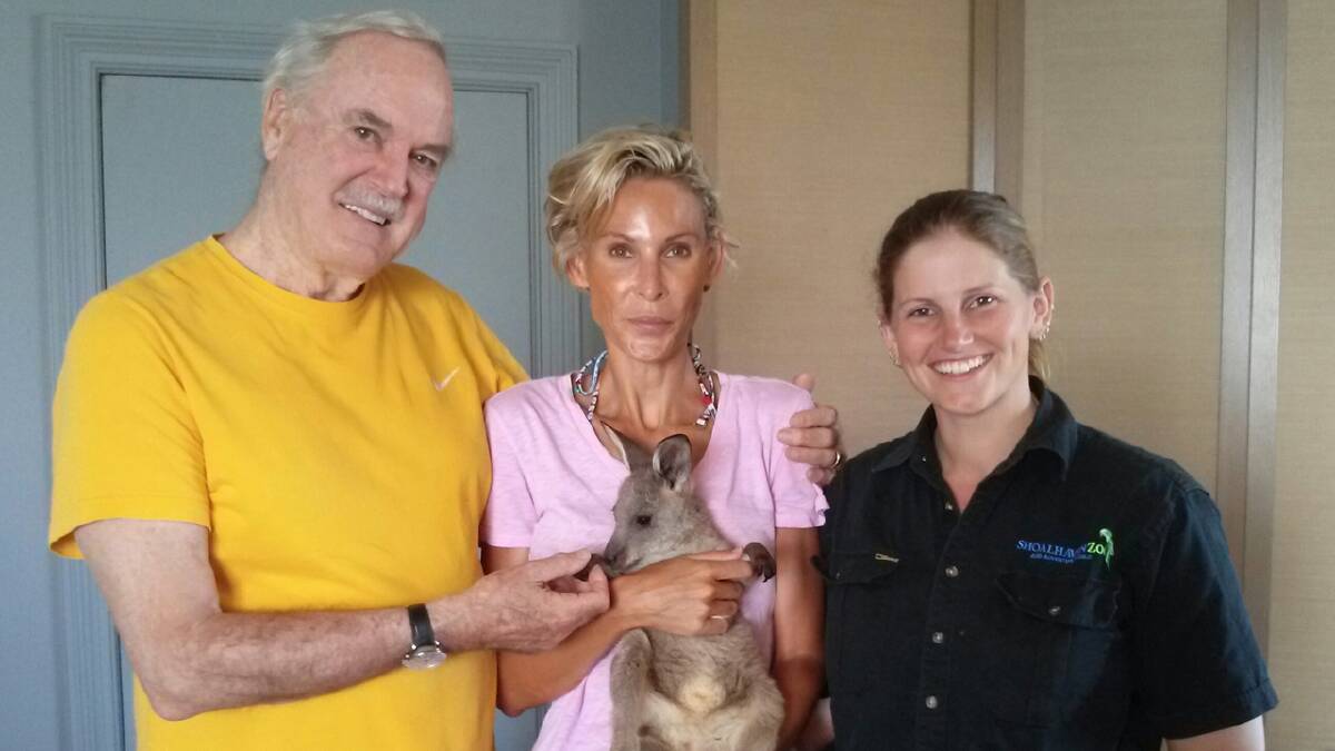 HOPPING GLAD: Shoalhaven Zoo senior keeper Jeni Brown with John Cleese and his wife Jennifer Wade and eight-month-old joey Honey during a special birthday visit in Sydney. BELOW: Cleese as the irascible Basil Fawlty. 