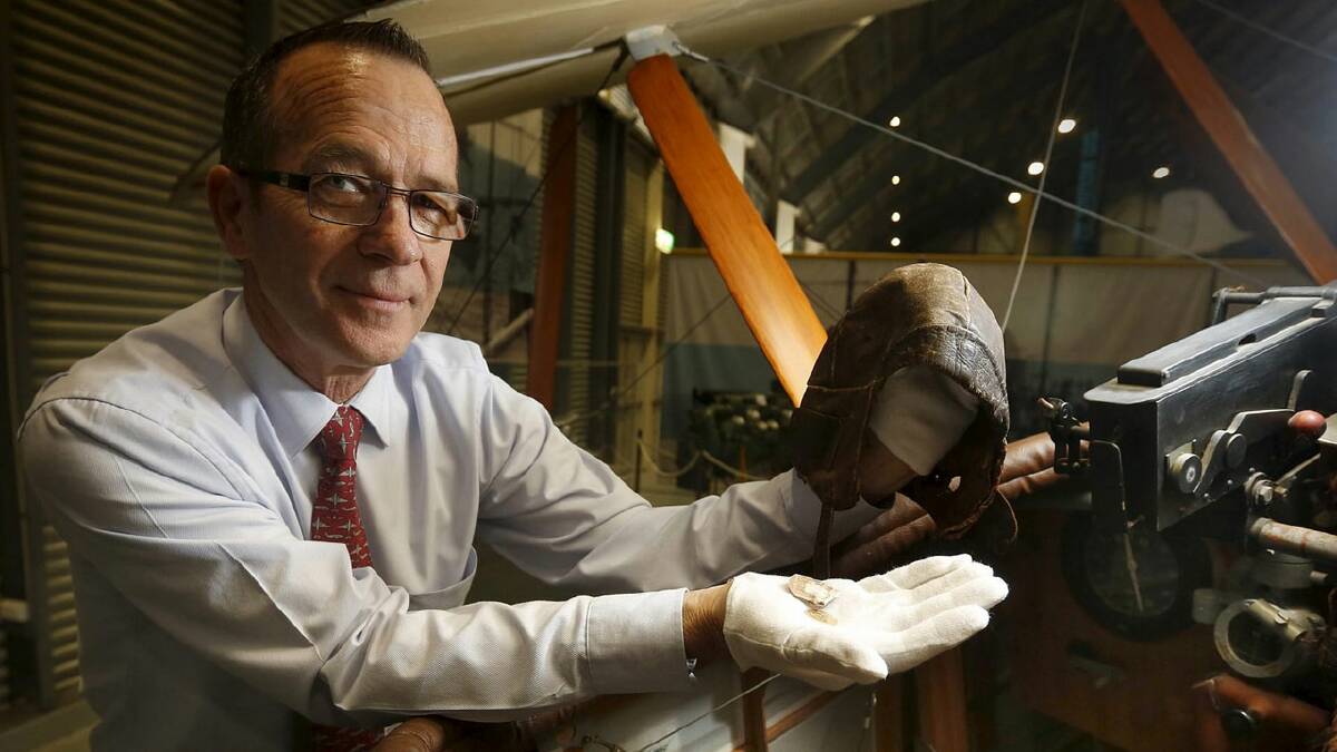 HISTORIC DISCOVERY: Fleet Air Arm Museum manager and senior curator Terry Hetherington with World War I fighter ace Alec Little’s flying helmet, which was found in an old Gladstone bag at a tip in Queensland. 