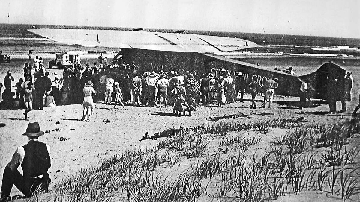 EXCITEMENT: The crowd on Seven Mile Beach mill around Smithy’s aircraft before its departure for New Zealand. RIGHT: Sir Charles Kingsford Smith.