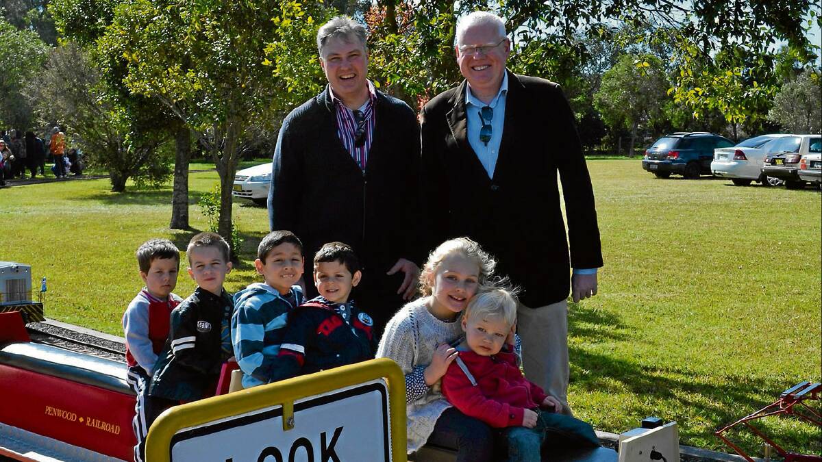 ON TRACK: Councillor Andrew Guile and Member for Kiama Gareth Ward celebrate the re-opening of Penwood Miniature Railway on Sunday with Jack and Riley Dove from North Nowra, Joshua and Lucas Stephanidis from North Nowra and Elsa and Ollie Guile from Berry. 